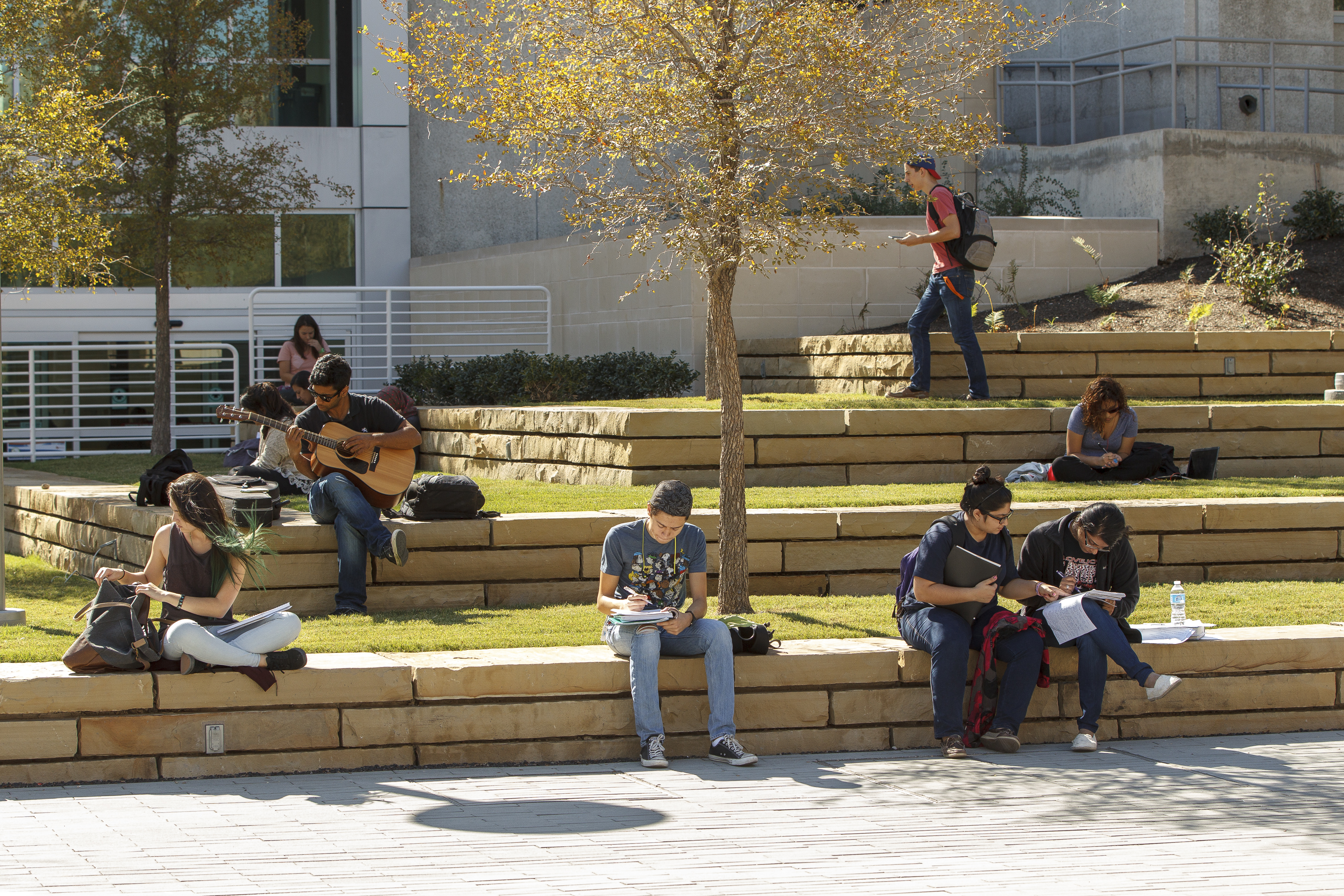 Students sit on ledges at TI Plaza