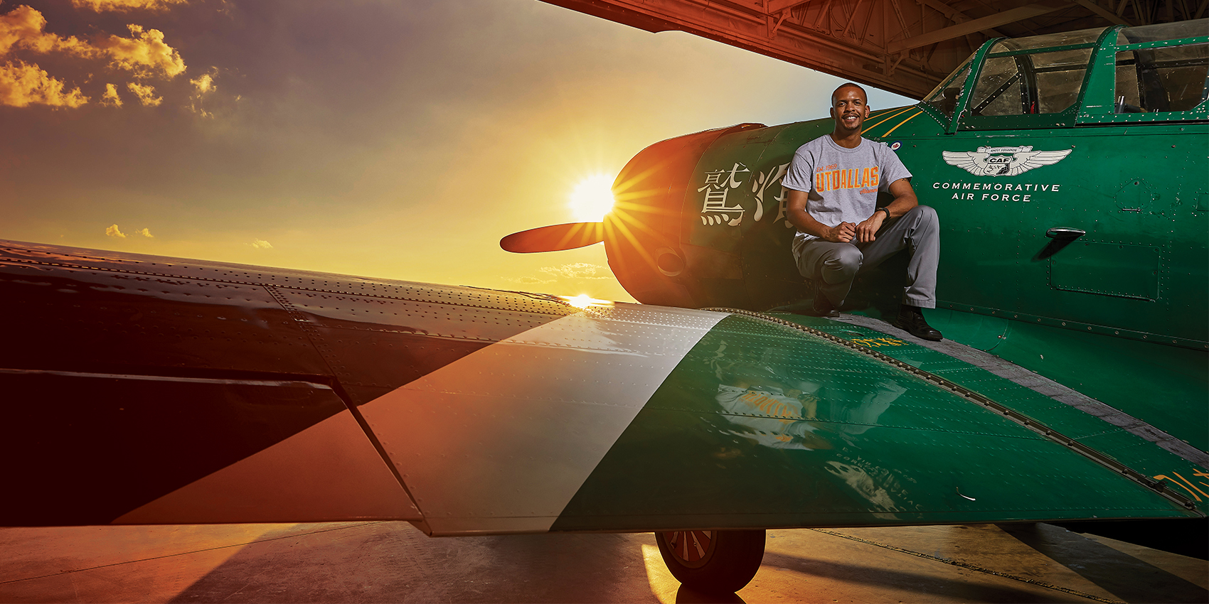 man sitting on wing of an airplane